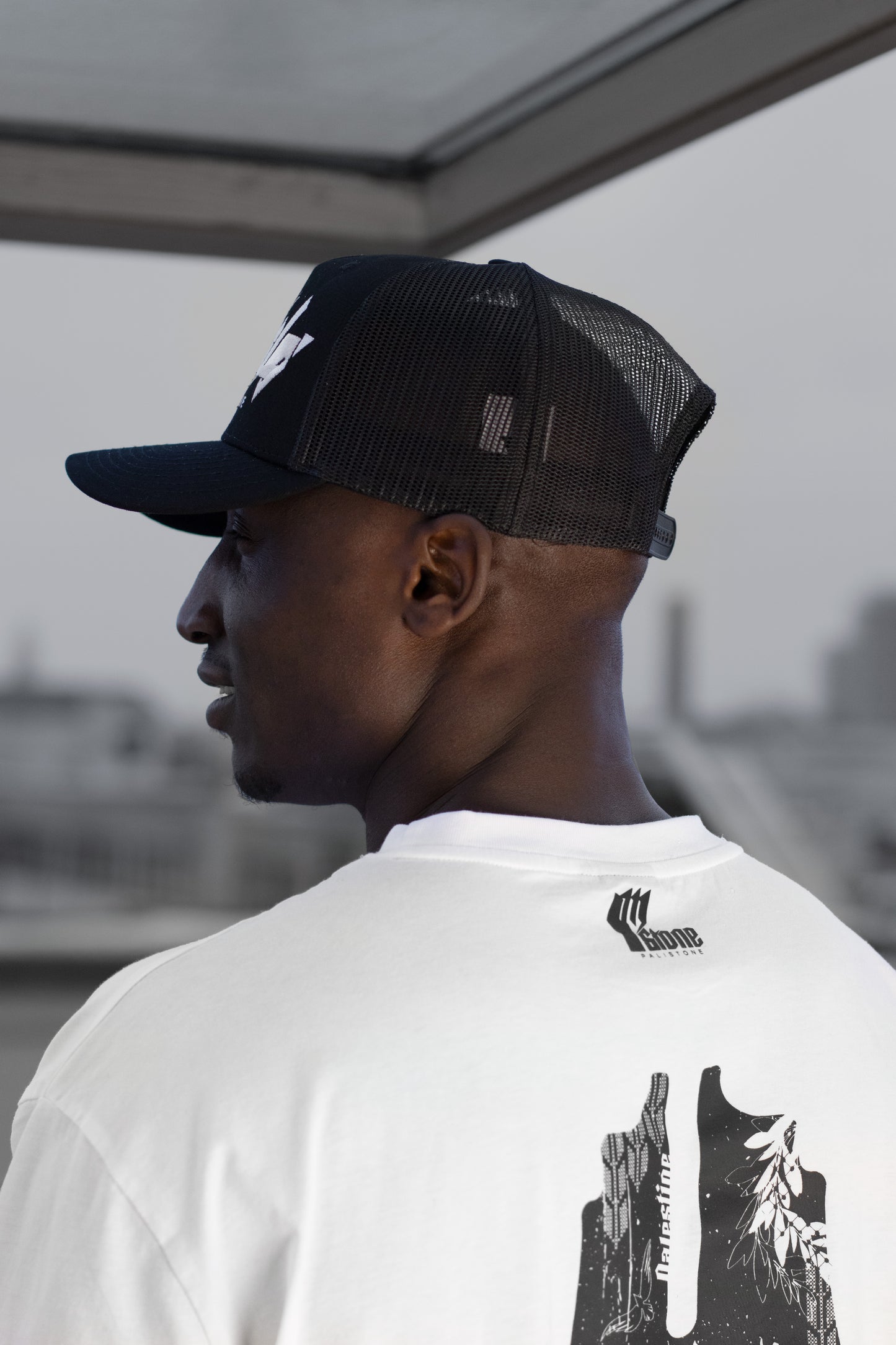 Embroidered Palestinian cap with ‘Palestine’ text in Arabic, black and white kufiya design.