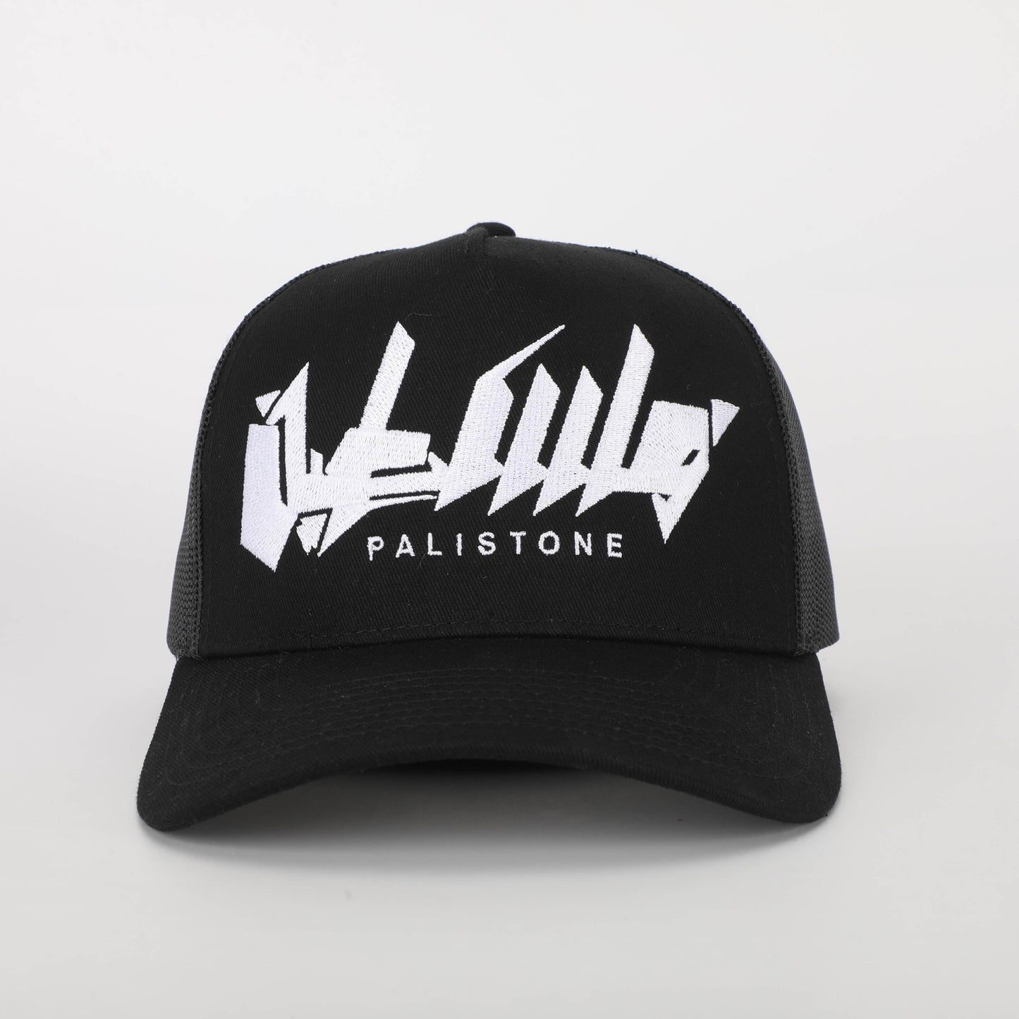 Embroidered Palestinian cap with ‘Palestine’ text in Arabic, black and white keffiyeh design.