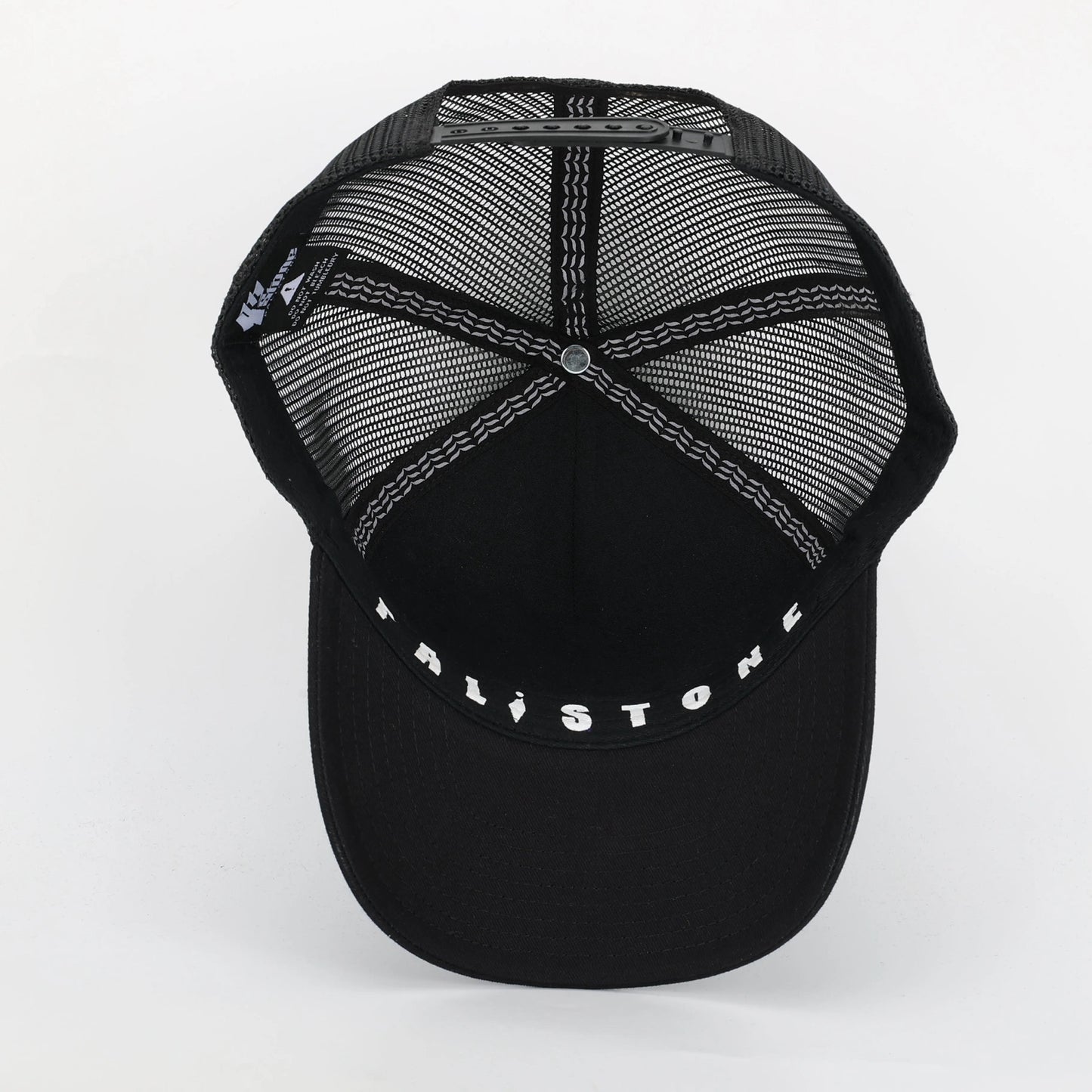 Embroidered Palestinian cap with ‘Palestine’ text in Arabic, black and white kufiya design.