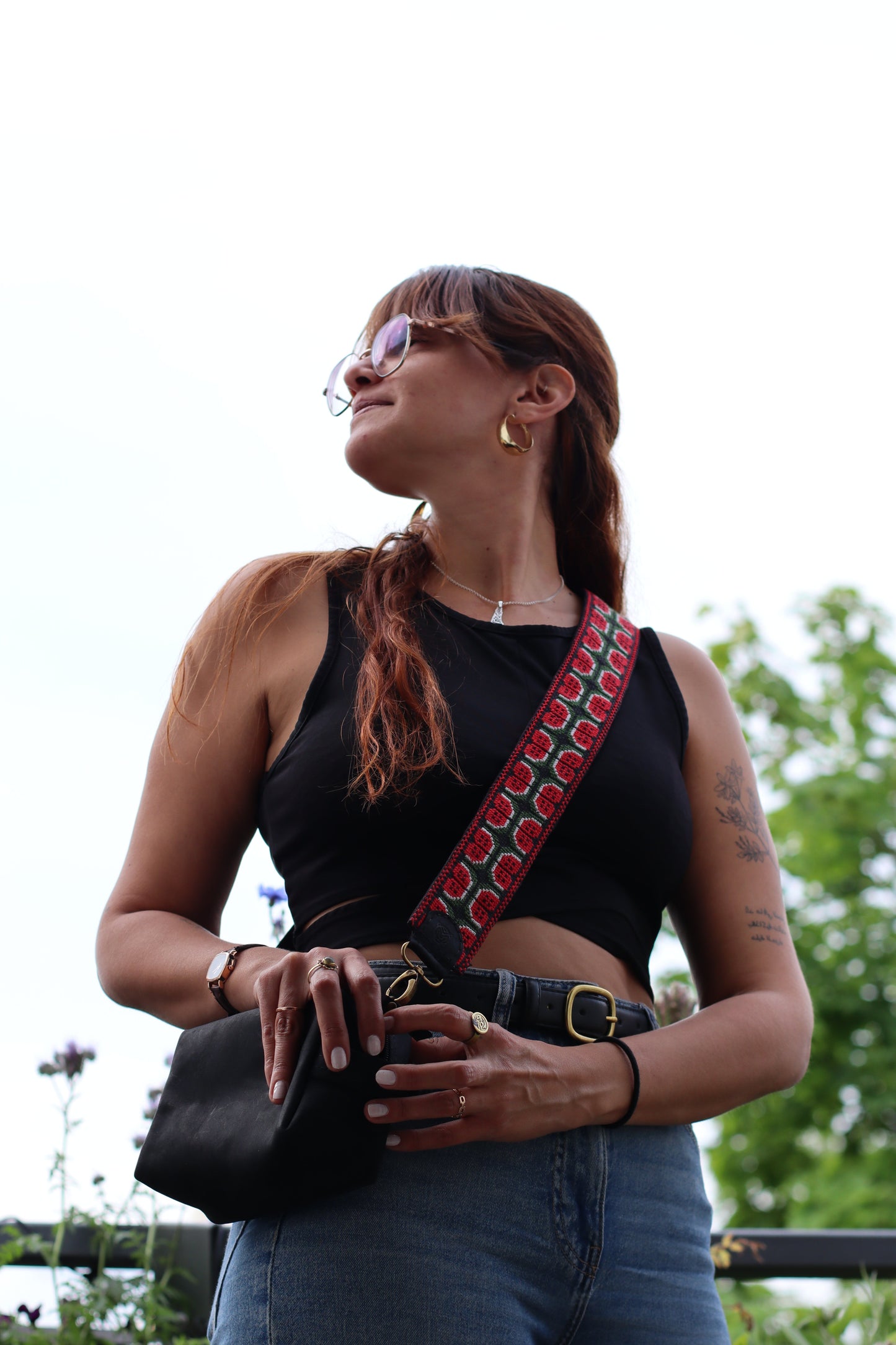 A girl wearing a Handmade leather belt with traditional embroidery watermelon from Hebron, Palestine, PaliStone brand.