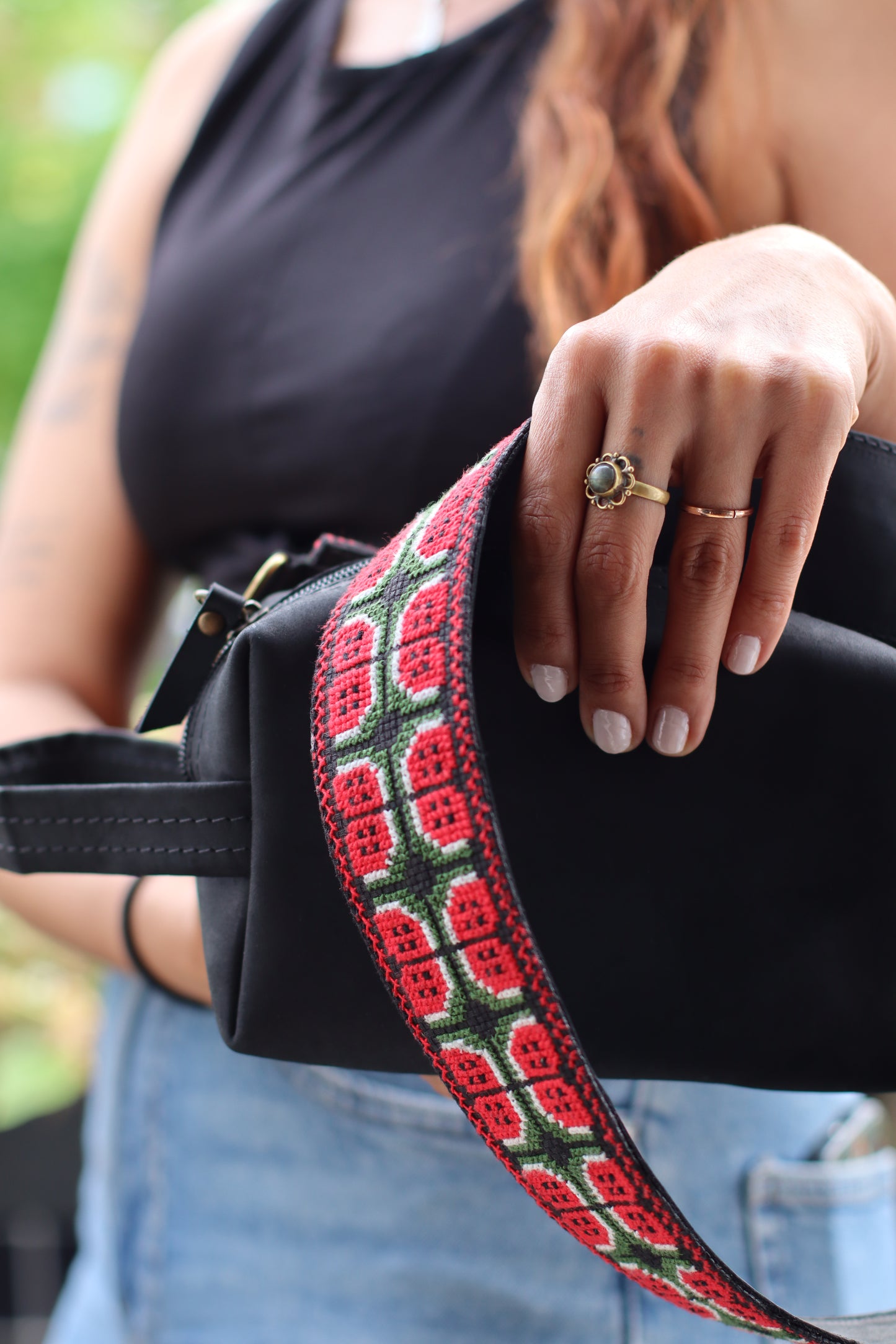A girl wearing a Handmade leather belt with traditional embroidery watermelon from Hebron, Palestine, PaliStone brand.