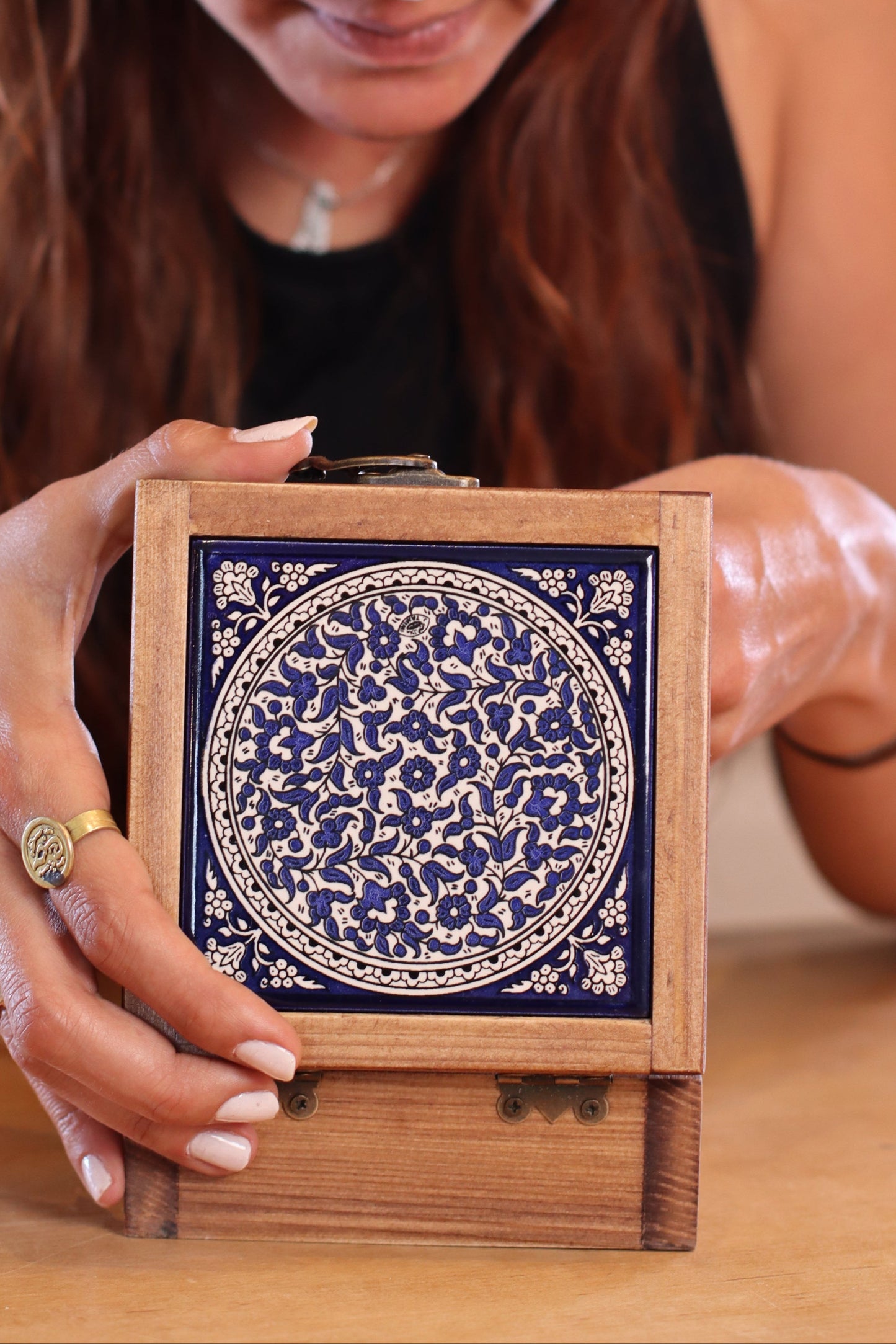 A girl using a handcrafted wooden box from Hebron, Palestine, Ceramic box - palistone brand