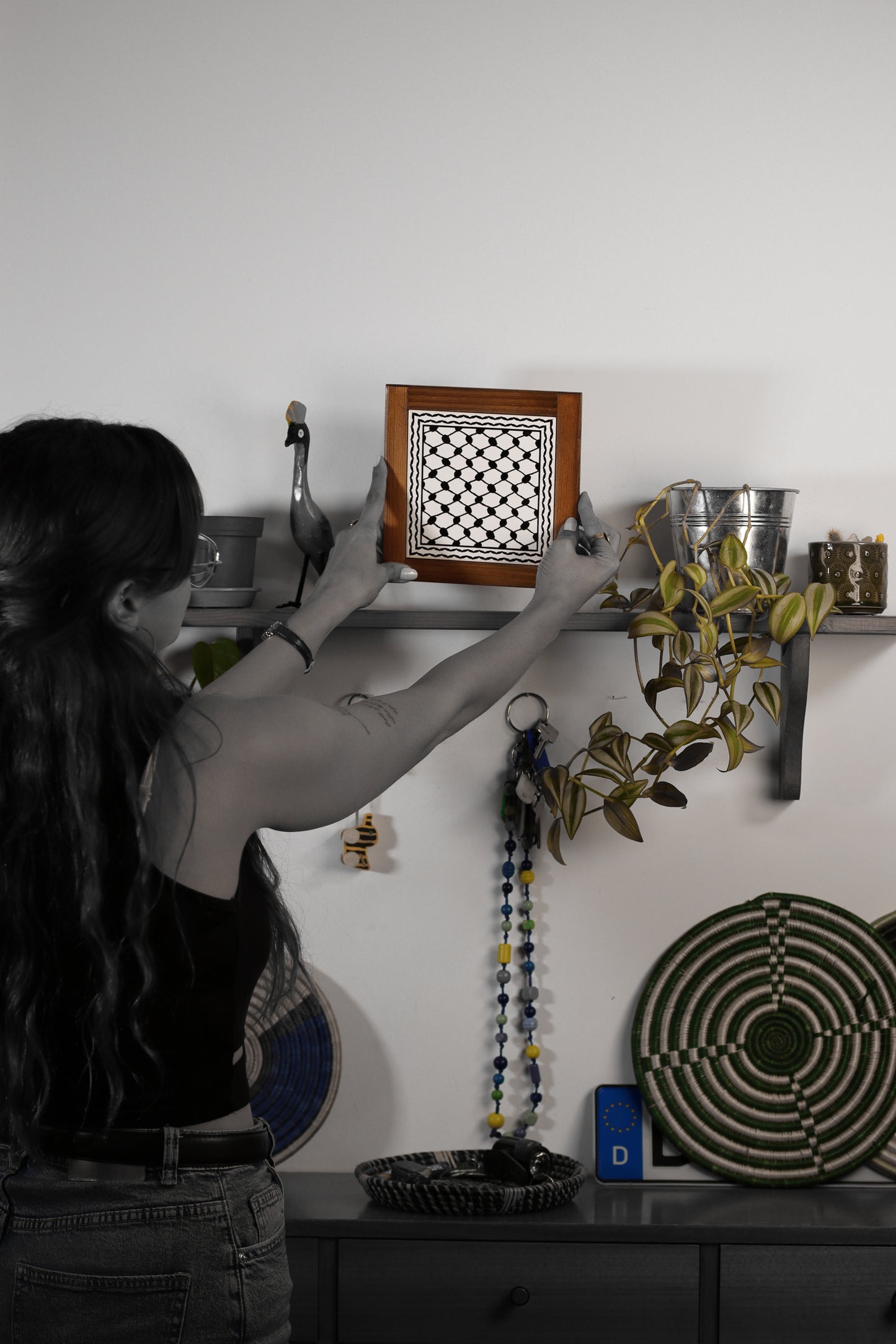 “Handcrafted wooden frame from Hebron, Palestine, featuring intricate ceramic decorations and vibrant, bold colors, showcasing traditional Palestinian craftsmanship.” palistone brand