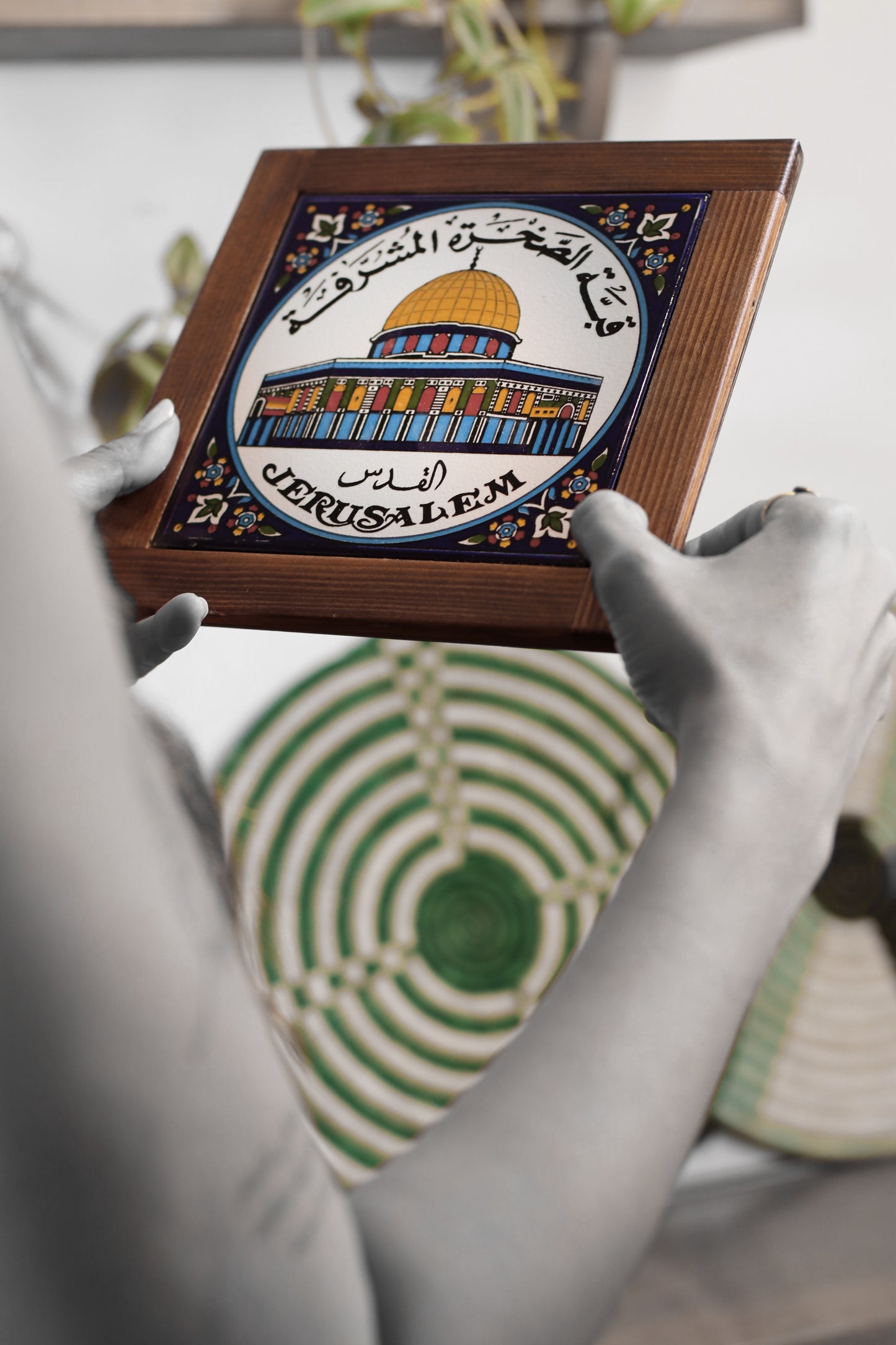 “Handcrafted wooden frame from Hebron, Palestine, featuring intricate ceramic decorations and vibrant, bold colors, showcasing traditional Palestinian craftsmanship.” palistone brand