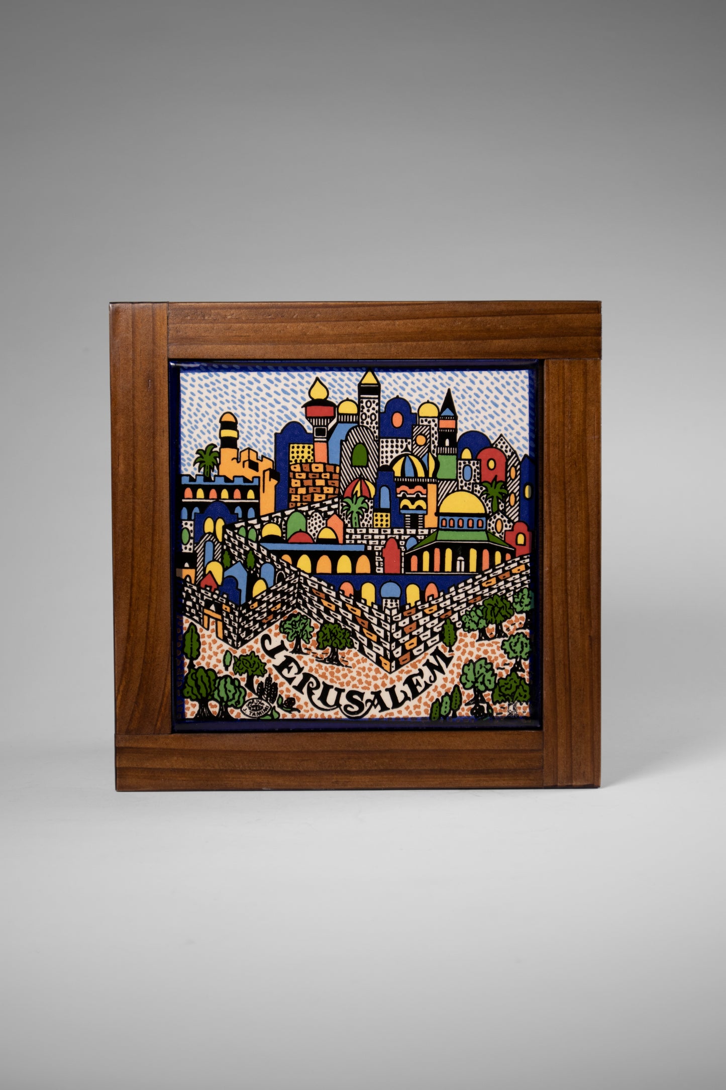 “Handcrafted wooden frame from Hebron, Palestine, featuring intricate ceramic decorations and vibrant, bold colors, showcasing traditional Palestinian craftsmanship.” palistone brand