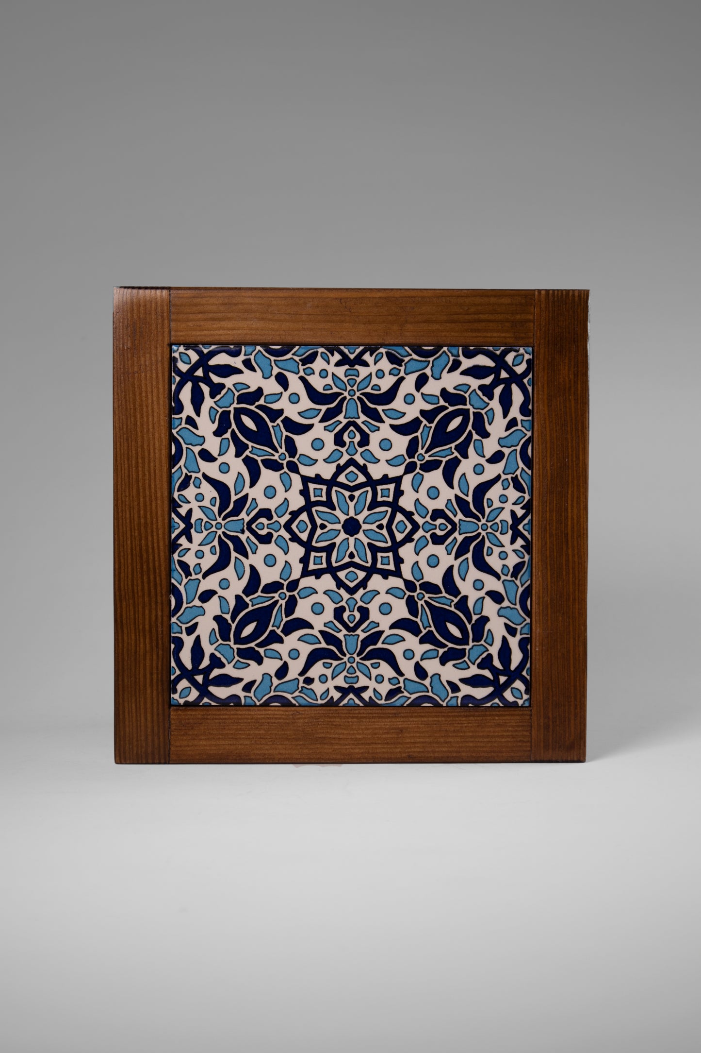 “Handcrafted wooden frame from Hebron, Palestine, featuring intricate ceramic decorations and vibrant, bold colors, showcasing traditional Palestinian craftsmanship.” palistone brand