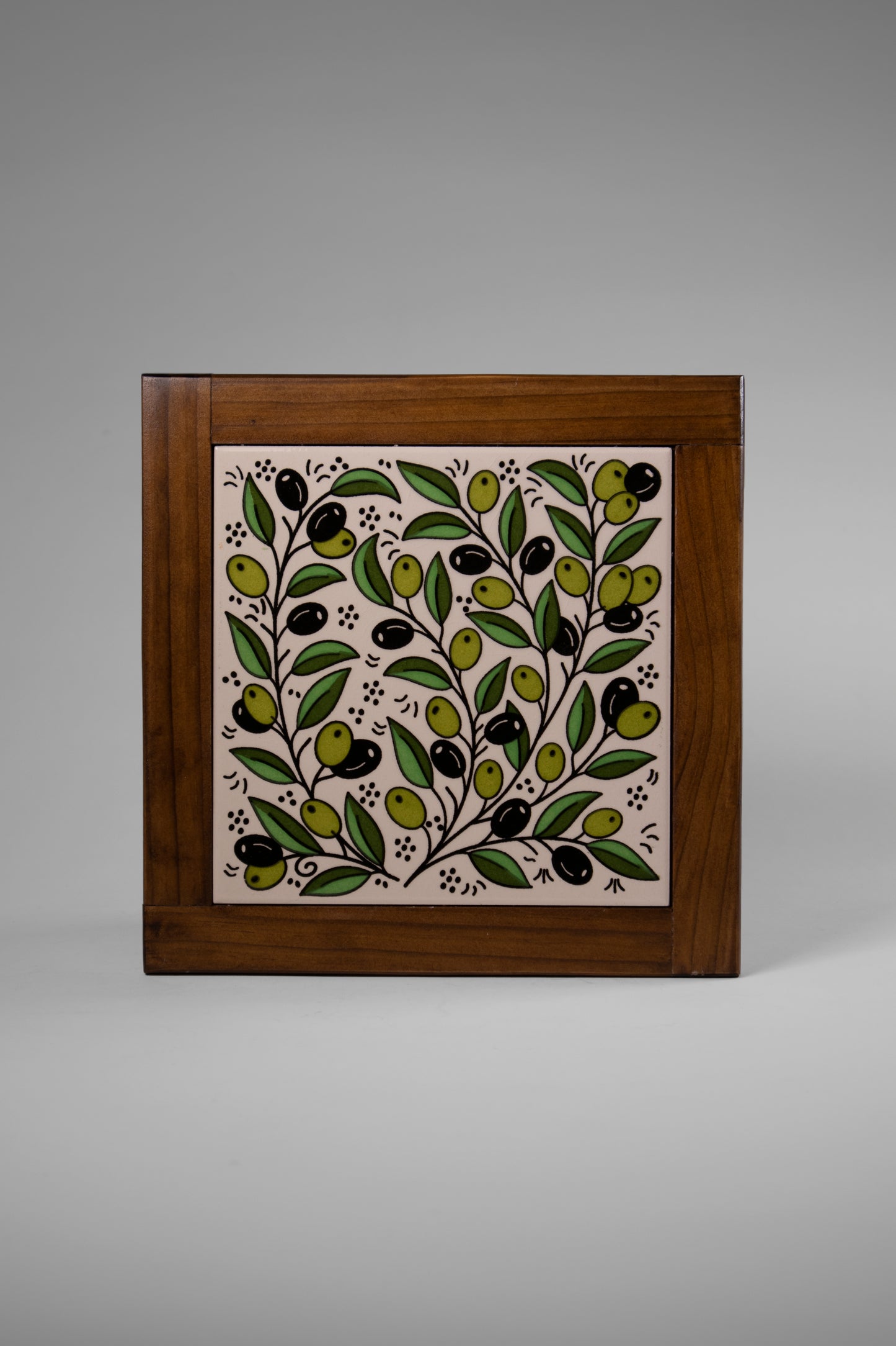 “Handcrafted wooden frame from Hebron, Palestine, featuring intricate ceramic decorations and vibrant, bold colors, showcasing traditional Palestinian craftsmanship.” palistone brand