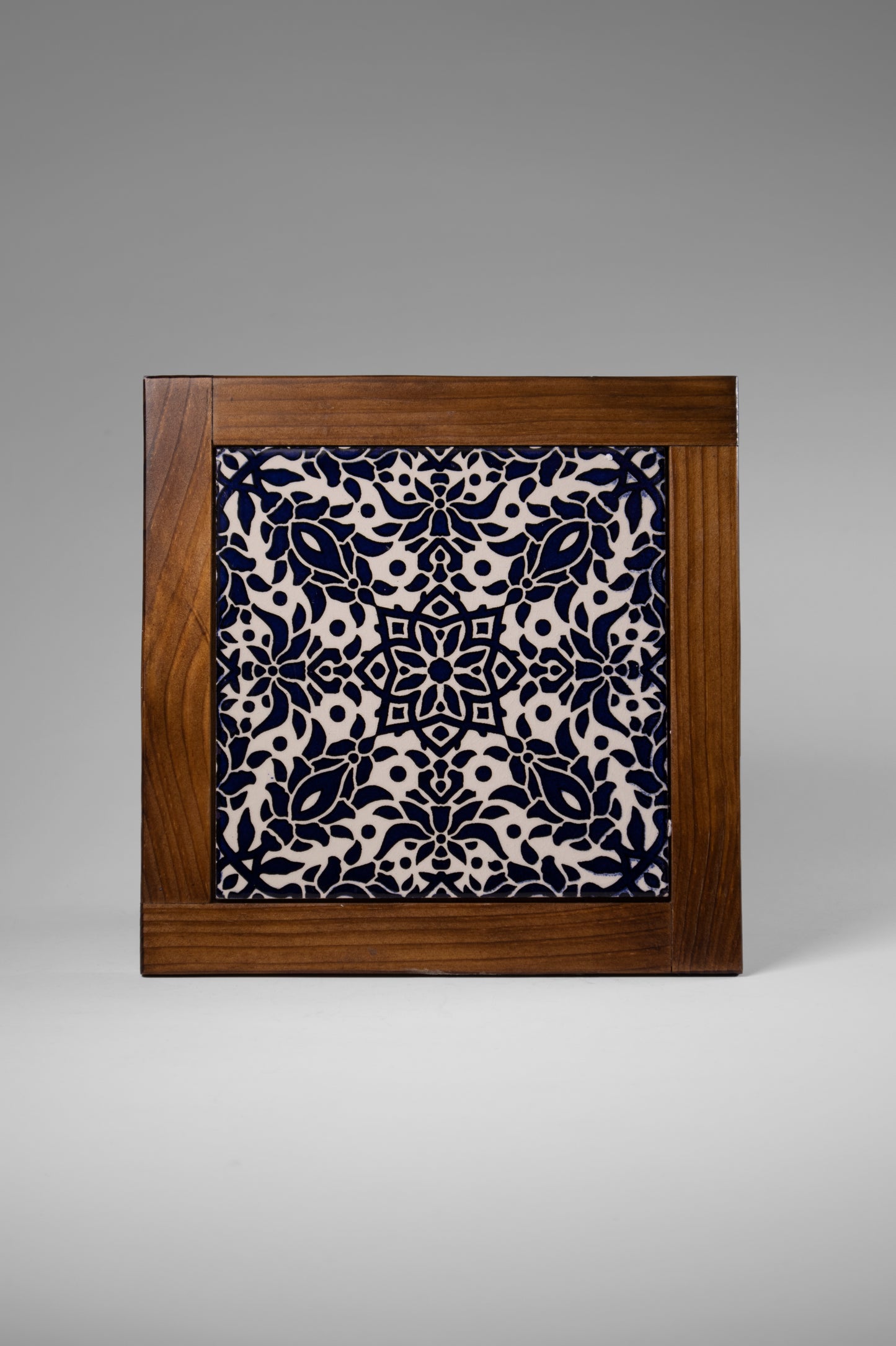 “Handcrafted wooden frame from Hebron, Palestine, featuring intricate ceramic decorations and vibrant, bold colors, showcasing traditional Palestinian craftsmanship.” palistone brand
