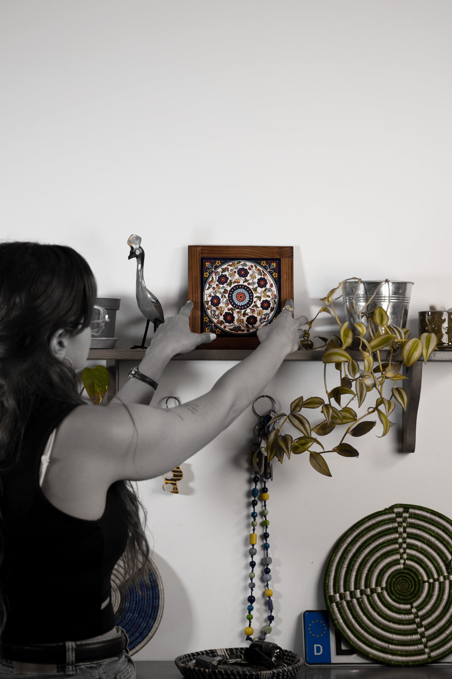 “Handcrafted wooden frame from Hebron, Palestine, featuring intricate ceramic decorations and vibrant, bold colors, showcasing traditional Palestinian craftsmanship.” palistone brand