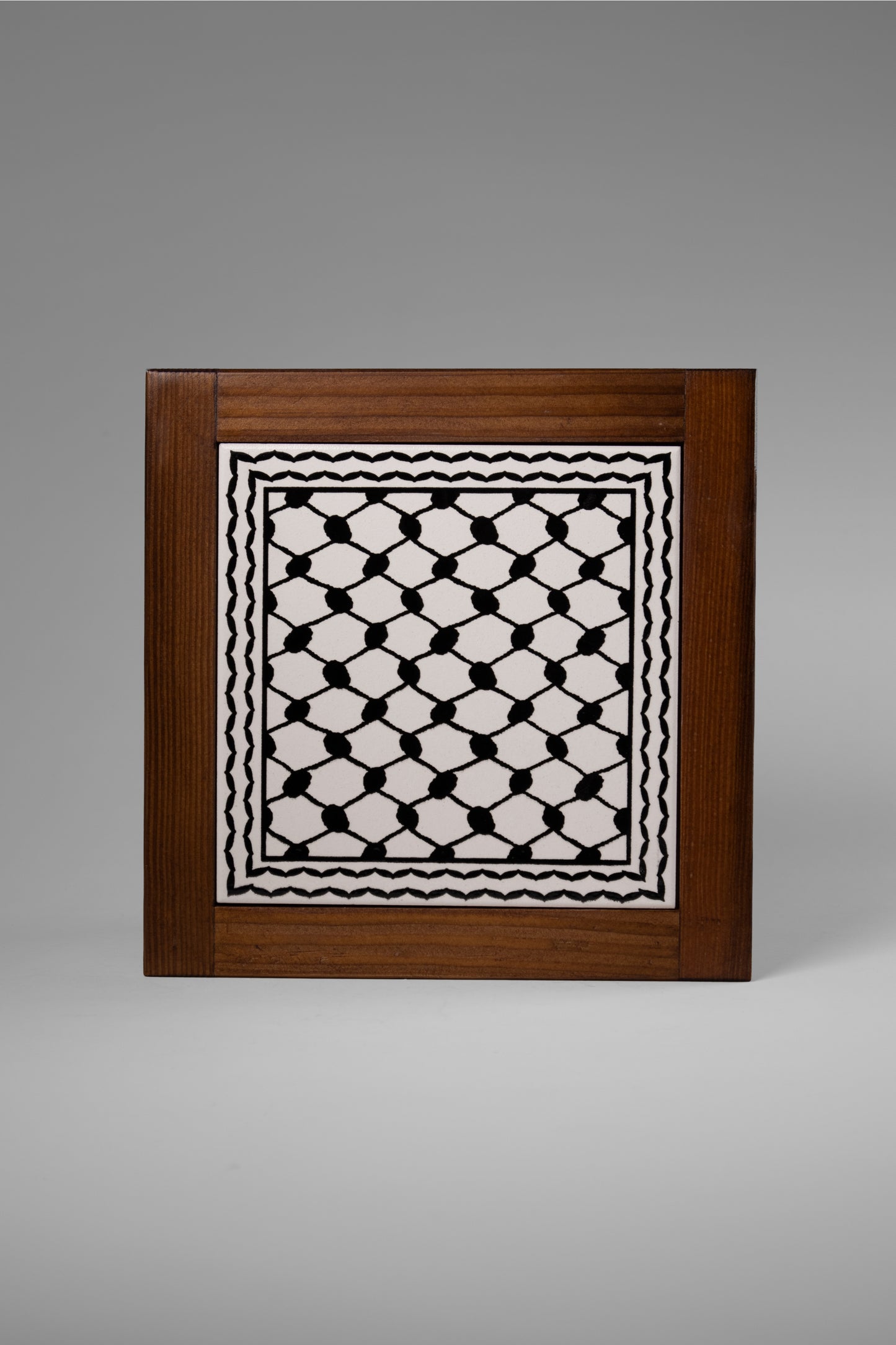 “Handcrafted wooden frame from Hebron, Palestine, featuring intricate ceramic decorations and vibrant, bold colors, showcasing traditional Palestinian craftsmanship.” palistone brand