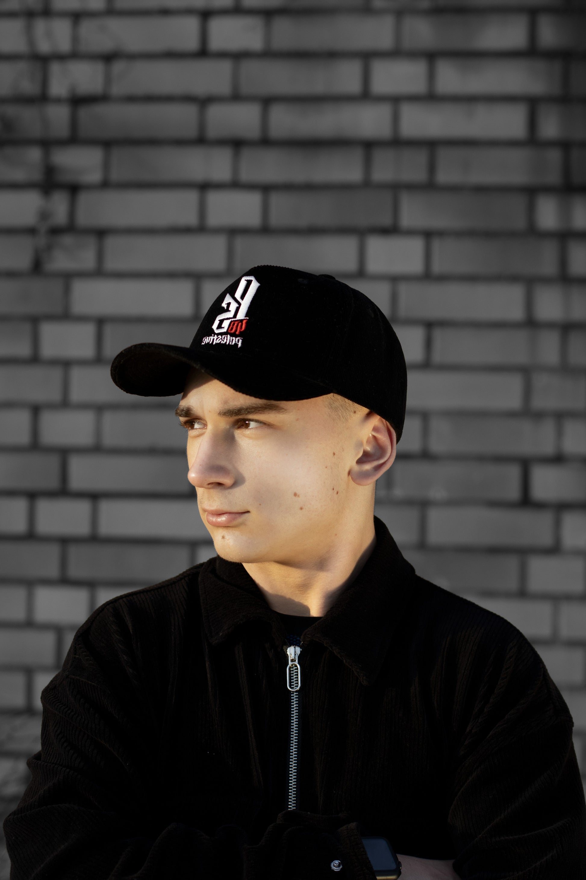 Embroidered Palestinian cap with ‘Palestine’ text in Arabic, black and white kufiya design.