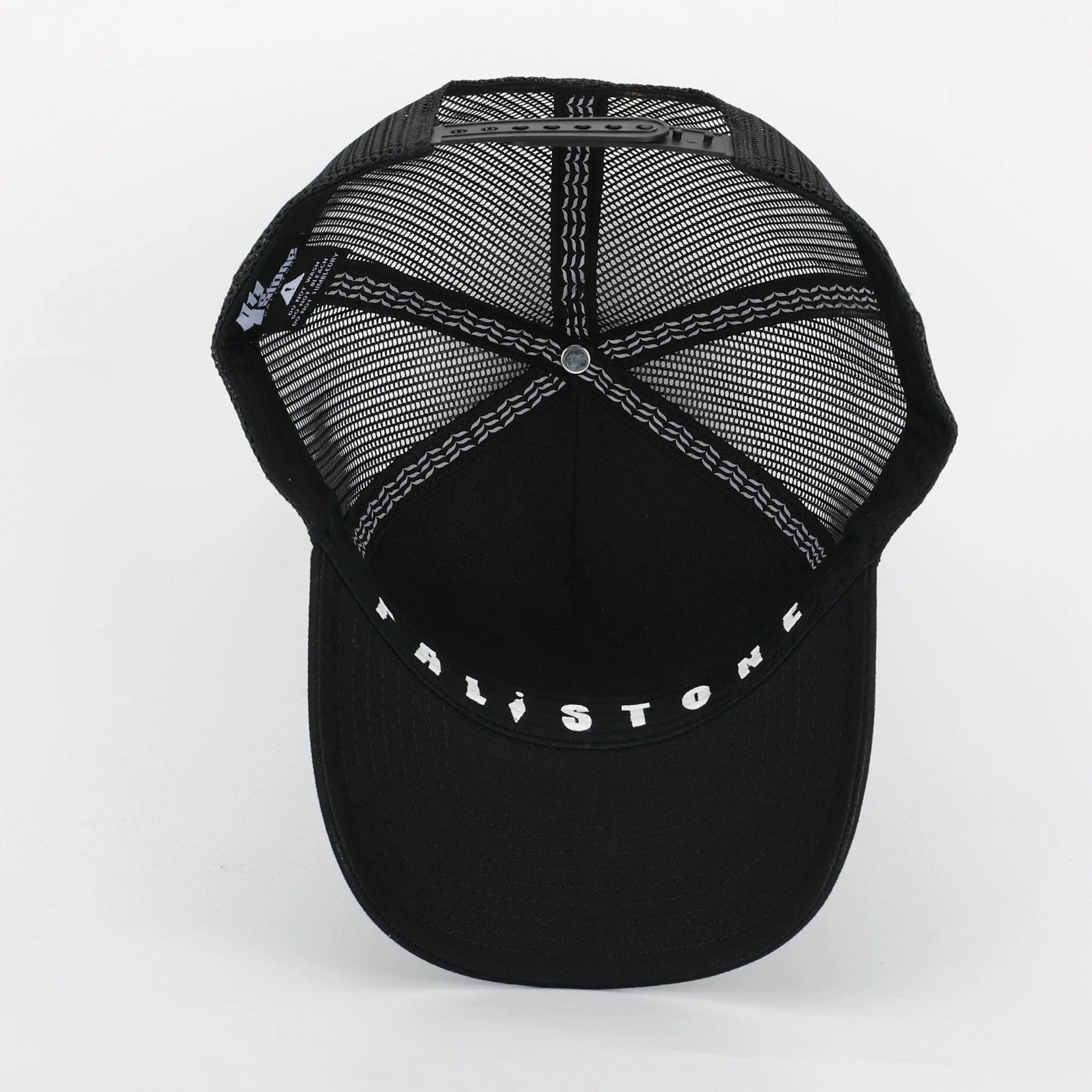 Embroidered Palestinian cap with ‘Palestine’ text in Arabic, black and white kufiya design.