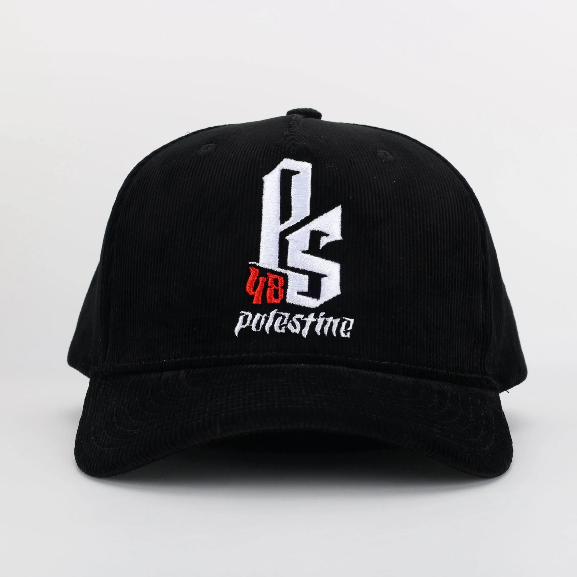 Embroidered Palestinian cap with ‘Palestine’ text in Arabic, black and white kufiya design.