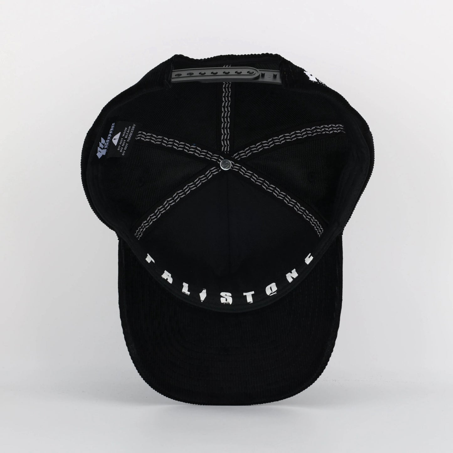 Embroidered Palestinian cap with ‘Palestine’ text in Arabic, black and white kufiya design.