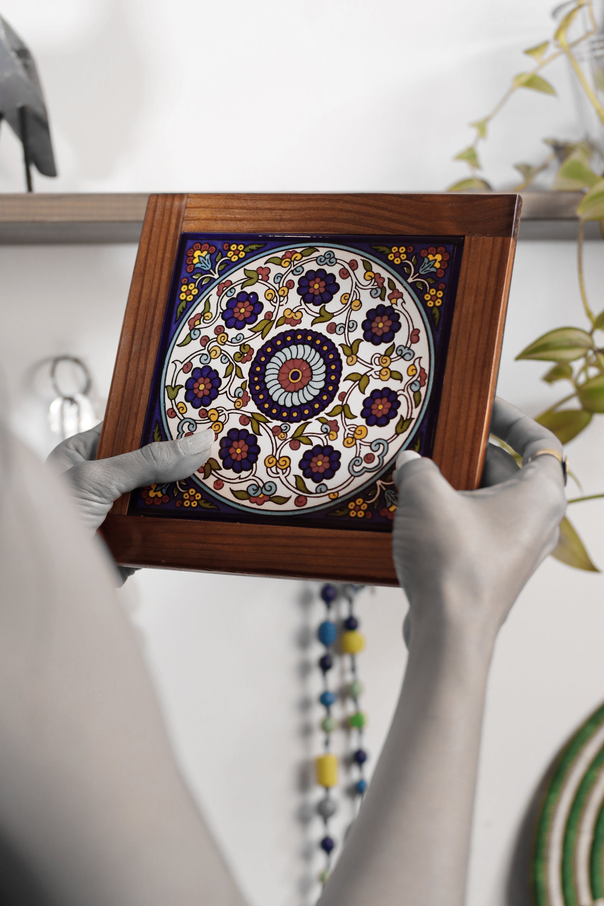 “Handcrafted wooden frame from Hebron, Palestine, featuring intricate ceramic decorations and vibrant, bold colors, showcasing traditional Palestinian craftsmanship.” palistone brand