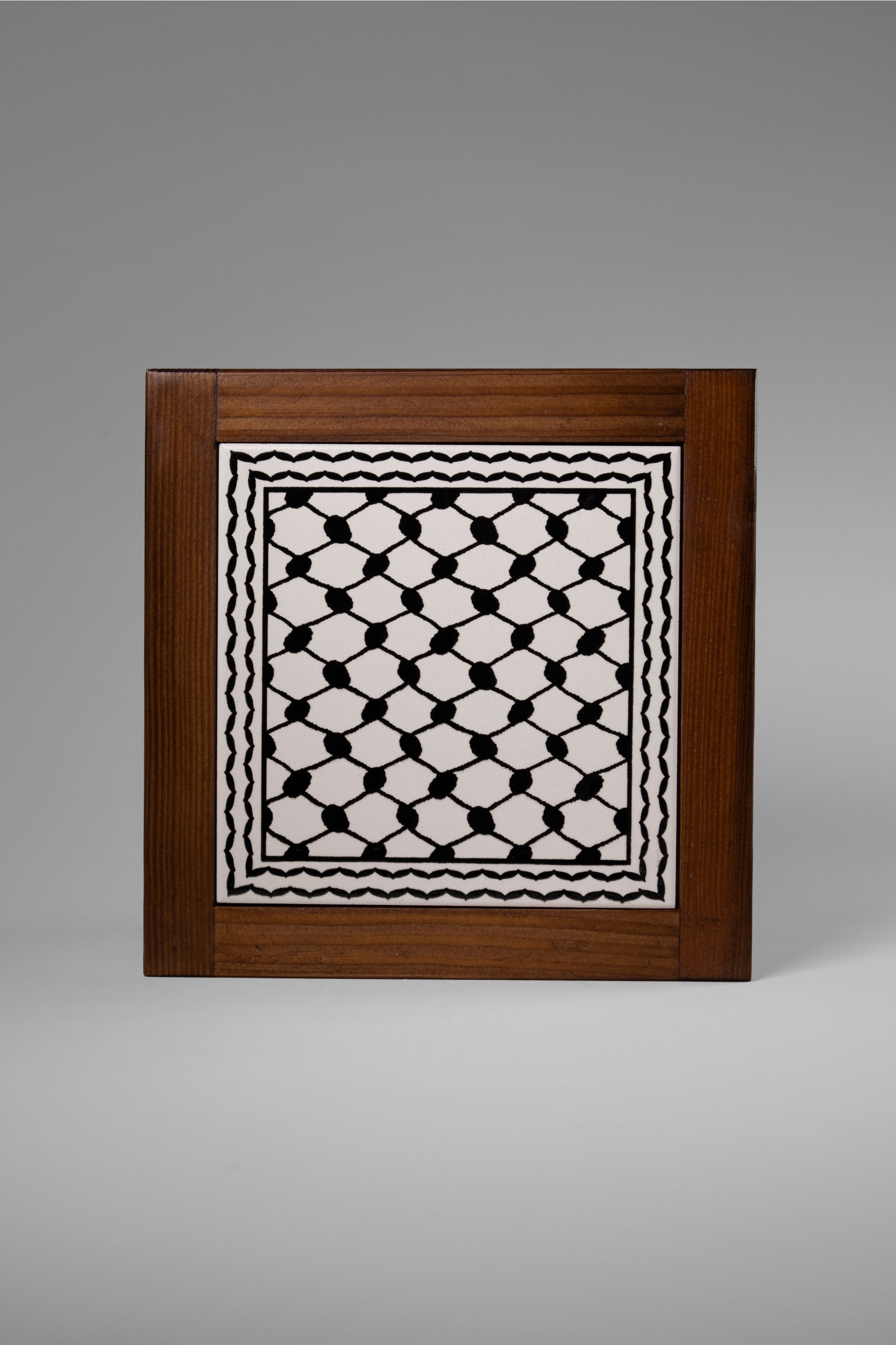 “Handcrafted wooden frame from Hebron, Palestine, featuring intricate ceramic decorations and vibrant, bold colors, showcasing traditional Palestinian craftsmanship.” palistone brand