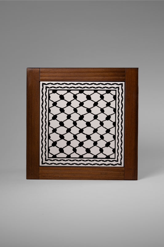 “Handcrafted wooden frame from Hebron, Palestine, featuring intricate ceramic decorations and vibrant, bold colors, showcasing traditional Palestinian craftsmanship.” palistone brand